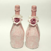 Large roses on champagne wedding bottles