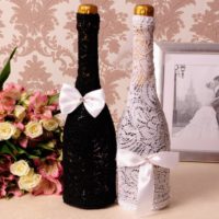 Lace trim champagne bottles for a wedding