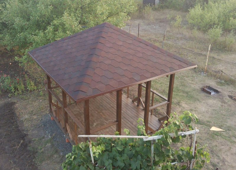 Simple wooden gazebo with soft roof
