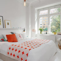 White bedroom and orange pillow