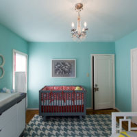 Painting the walls in mint color in the nursery for the baby