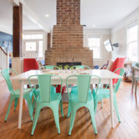 Brick fireplace and mint chairs