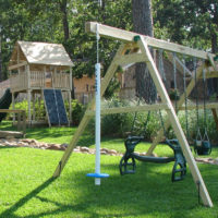 Playground with swings in the courtyard of a private plot