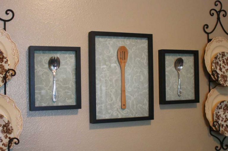 Pictures with spoons on a kitchen wall