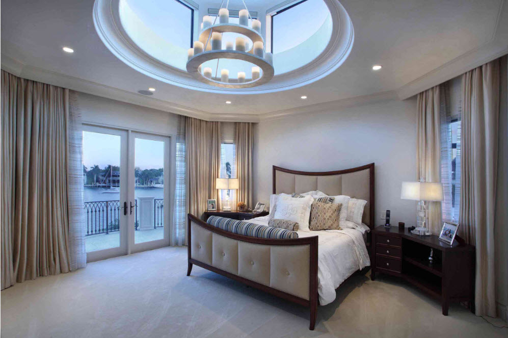 Bright bedroom with a dark neoclassical bed