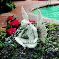 Figurine of an angel in a decor of a garden site