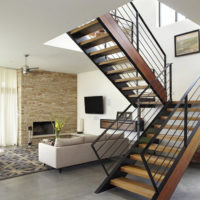 Staircase on a metal frame in the interior of a modern living room