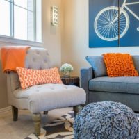 Orange pillow in a room with an interior in pastel colors