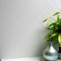 Small floral ornament on colored wallpaper