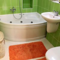 Corner bathtub and green ceramic tiles