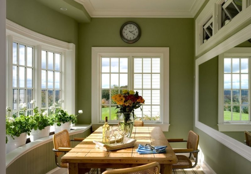 Living room in olive color with white window frames