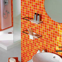 Orange mosaic in the interior of the bathroom of a city apartment