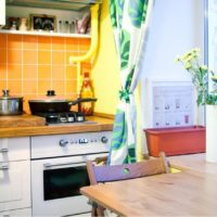 Orange tiled apron in the kitchen of a city apartment