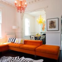 Upholstered furniture with orange pillows in the living room interior
