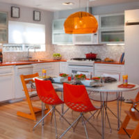 The use of bright orange shades in the interior of the kitchen