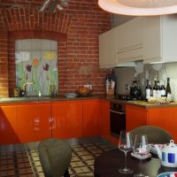 Orange color in the loft style kitchen