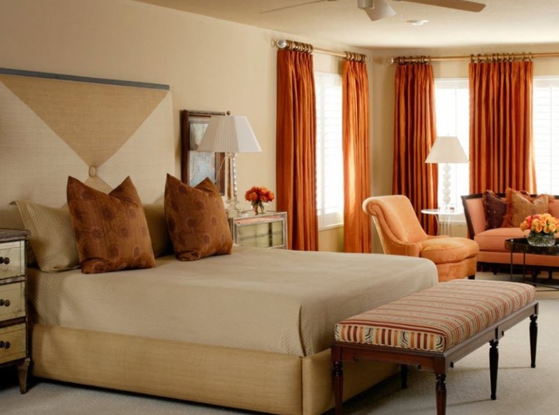 Orange curtains in the design of the bedroom