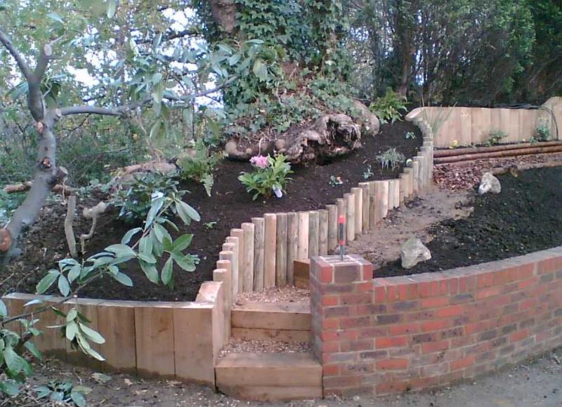 Wooden retaining wall combined with masonry