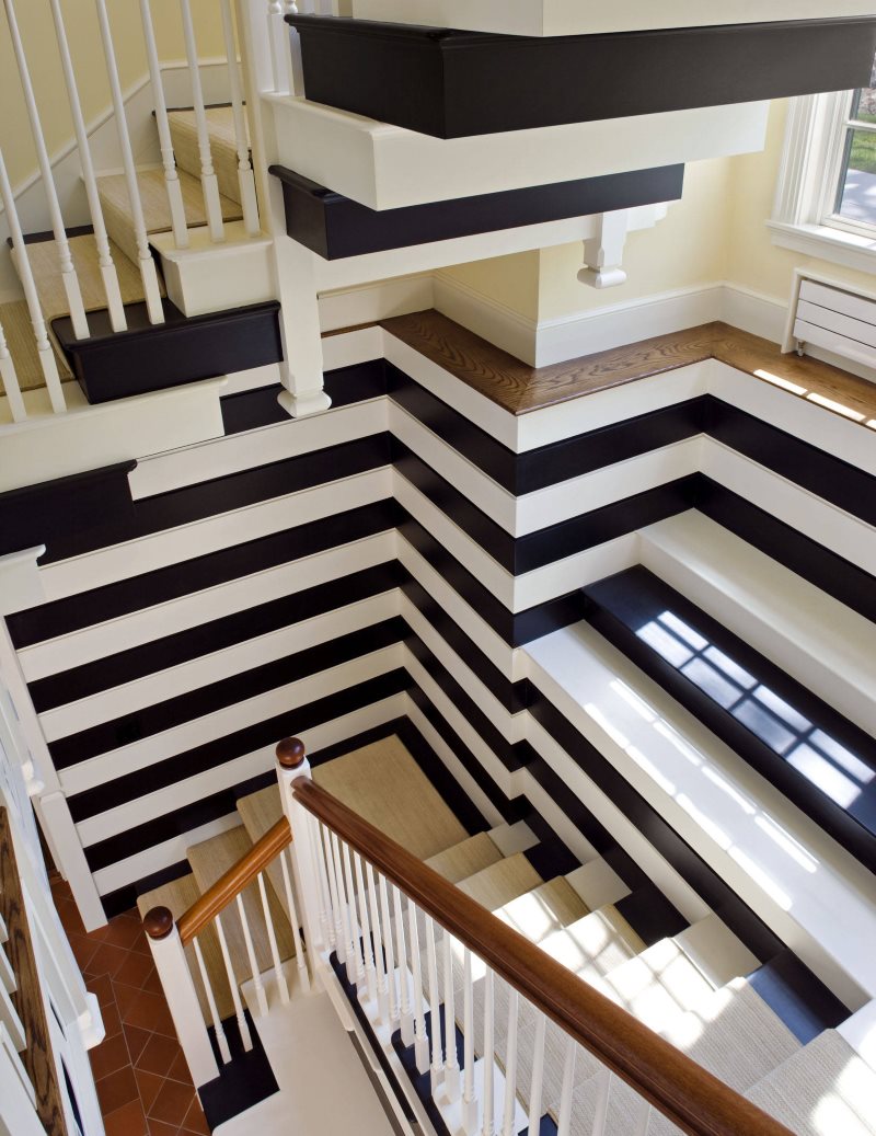 Striped staircase design in a three-story country house