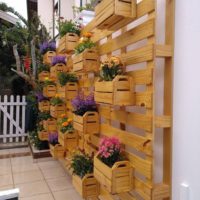 Vertical flowerbed of wooden boxes