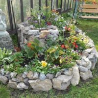 Spiral flower bed made of natural stone