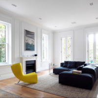Spacious bright living room with moldings on the windows