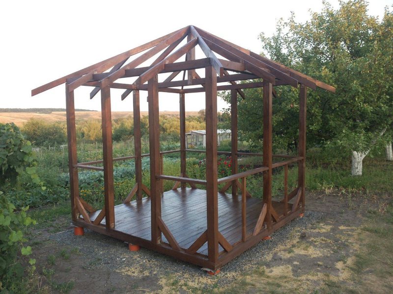 Frame of wooden arbor after treatment with stain