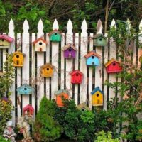 Decoration of a country fence with decorative birdhouses