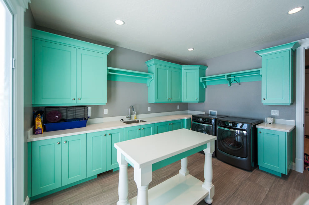 Mint facades of a kitchen set against a background of gray walls