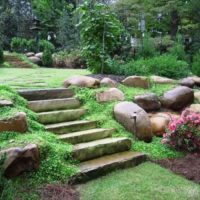 Natural stones in the design of the inclined section of the garden