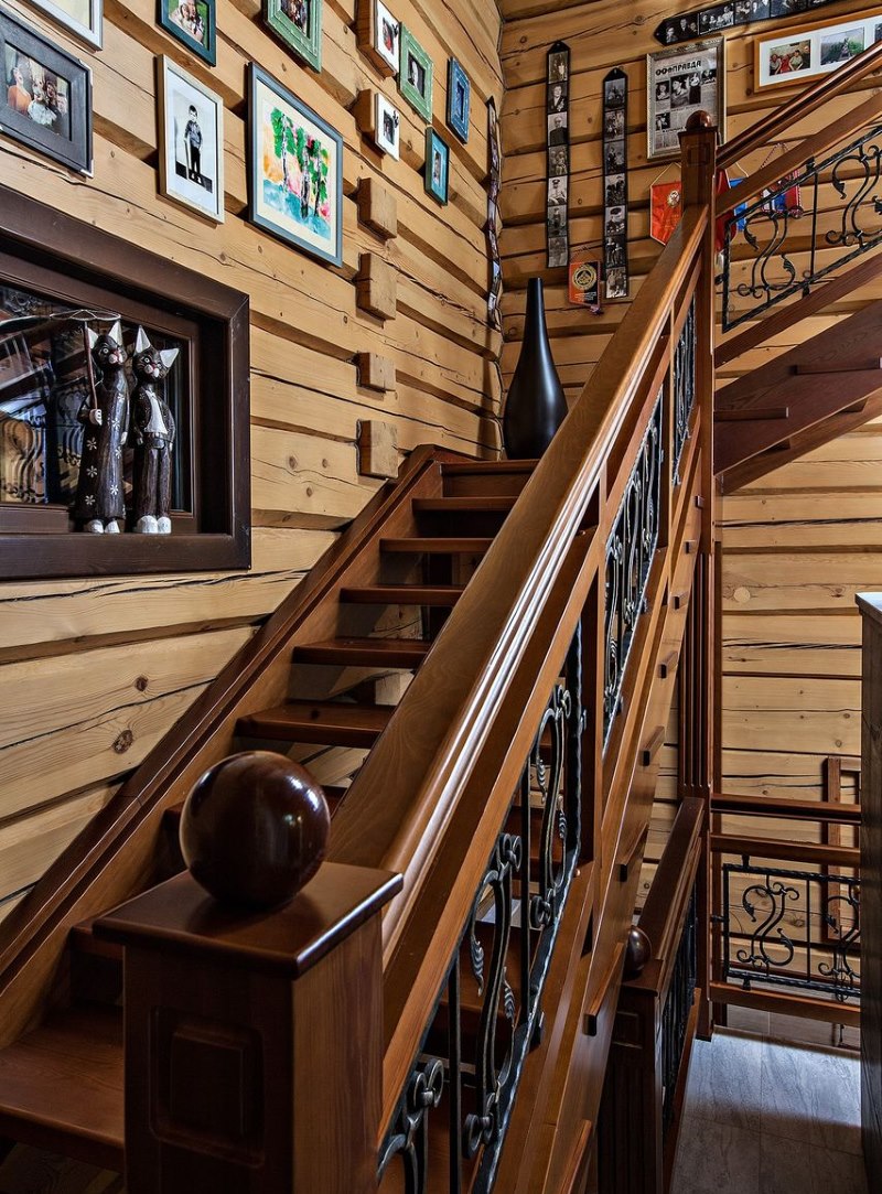 Staircase to the second floor in the interior of a wooden house
