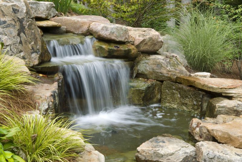 Artificial waterfall on the slope of a summer cottage