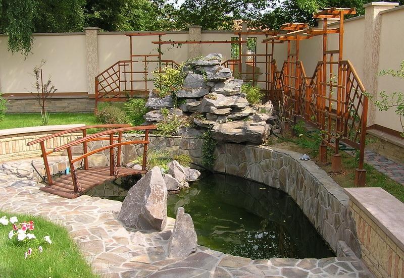Waterfall from stones in front of an artificial pond