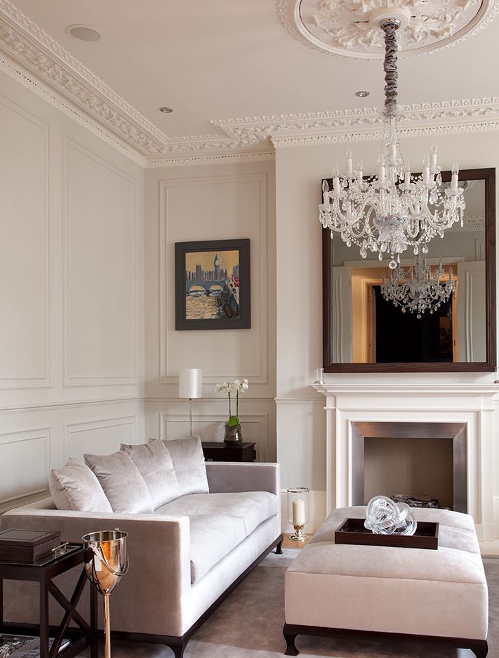 White glass chandelier on the ceiling with stucco moldings