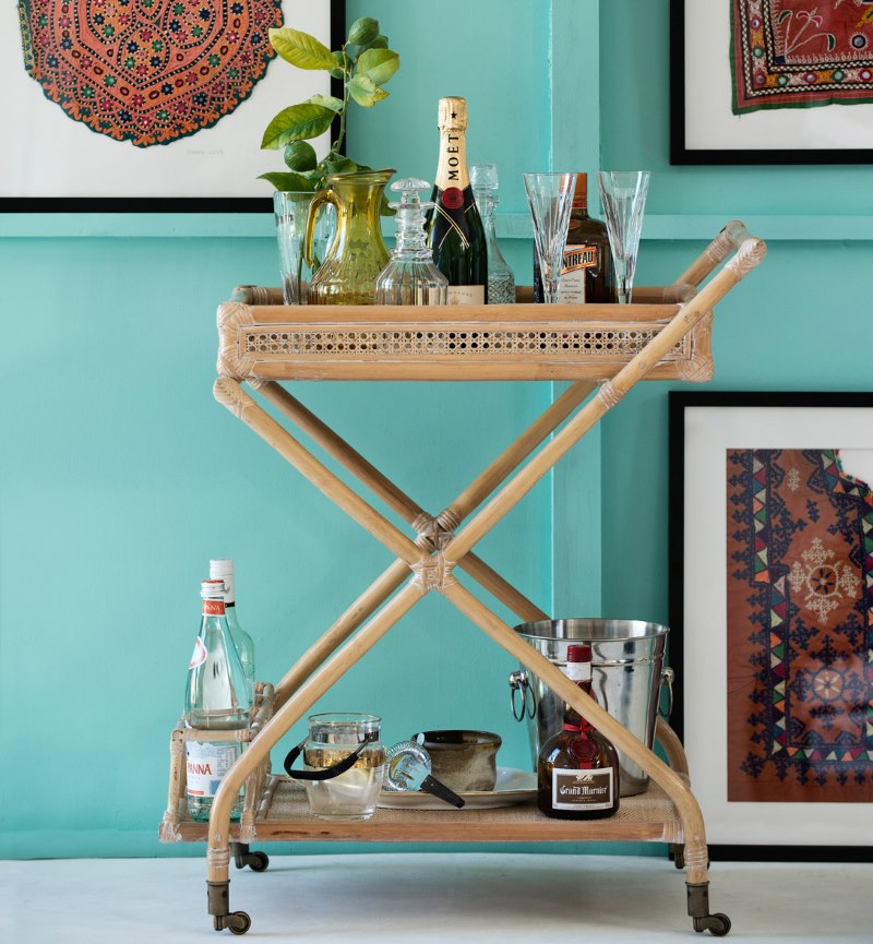 Serving wooden table on a mint color wall background