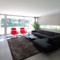Red chairs next to the black sofa