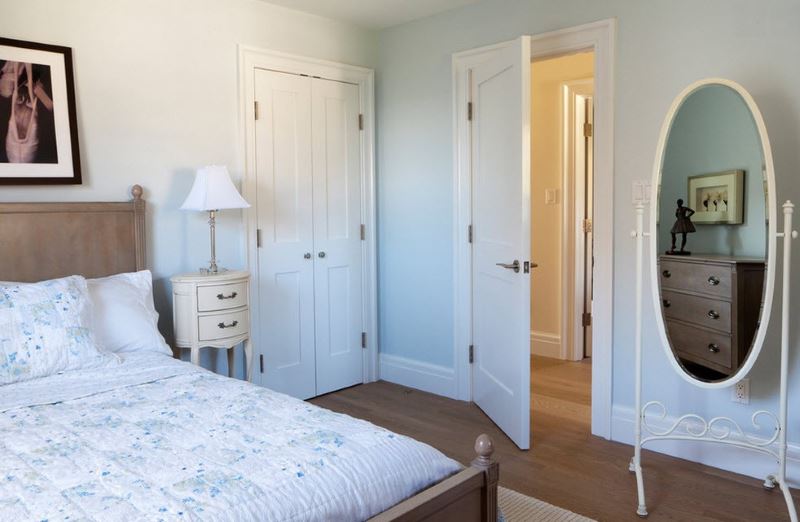 Ajar white door in spouses bedroom
