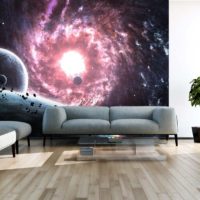 Space photo wallpaper over the sofa in the living room of a private house