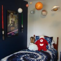 Planet decorations over a baby bed
