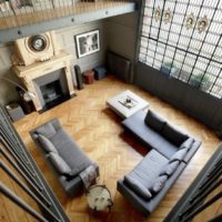 Top view of living room with parquet floor and leather furniture.