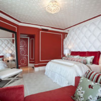 Red and white bedroom in a city apartment