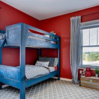 Blue bed in a red children's room