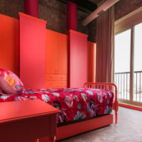 Red bedroom with metal bed