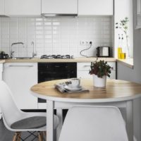 White kitchen with a round table