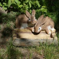 Figures de lièvres avec une mangeoire pour décorer le jardin