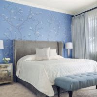 Blue wallpaper with flowers on the wall of a bedroom