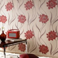 Large red flowers on the wallpaper in a room with a retro design