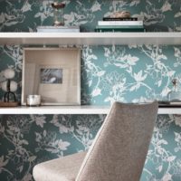 White shelves with decorations on the background of floral wallpaper