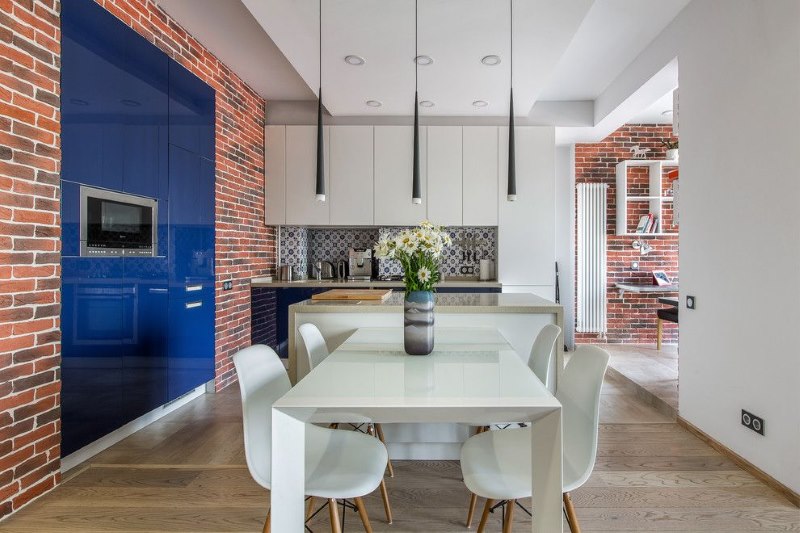 Brick wall in the design of the kitchen-living room in the style of contemporary