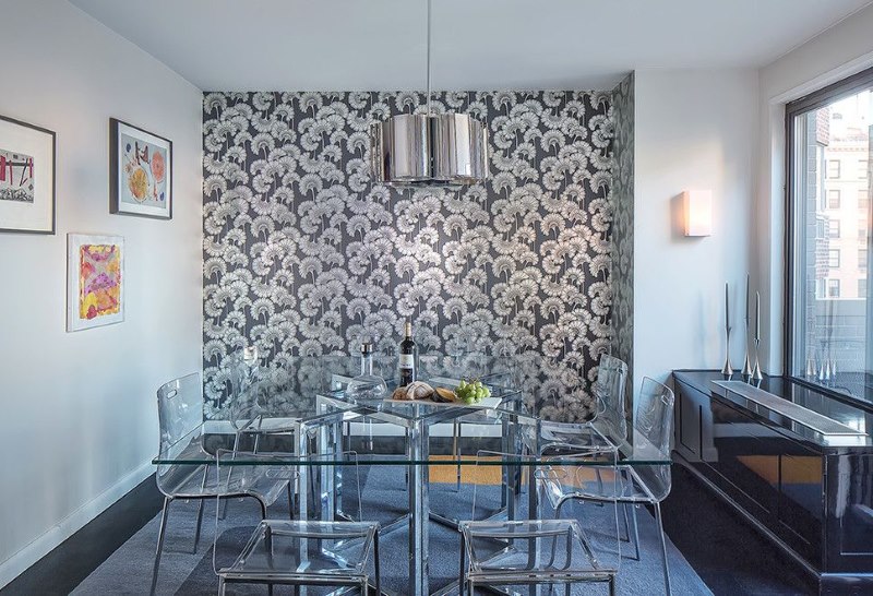 The interior of the dining area of ​​the kitchen space with floral wallpaper